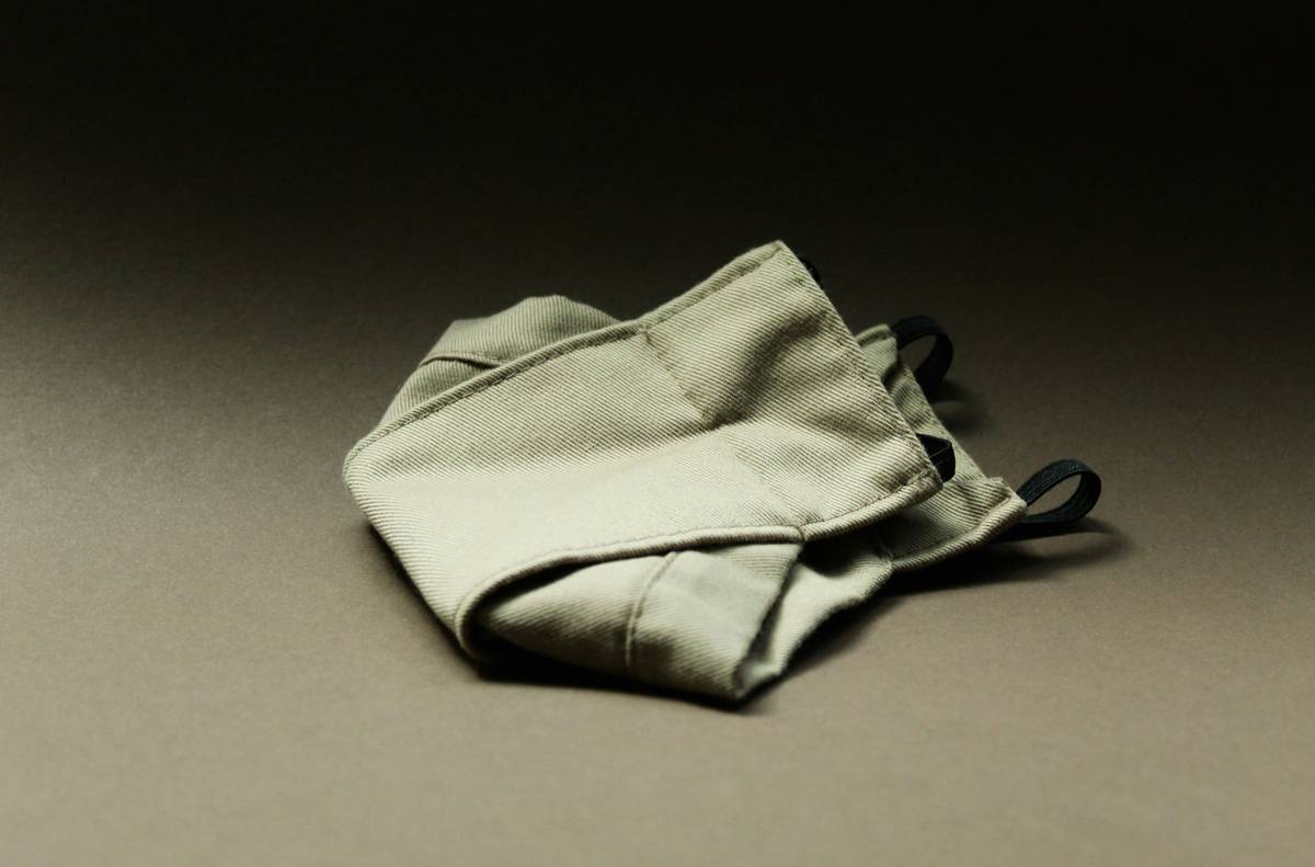 Close-up of a biodegradable cotton cloth drying on a bamboo dish rack, with visible cotton weave and no synthetic backing — biodegradable cotton cloth